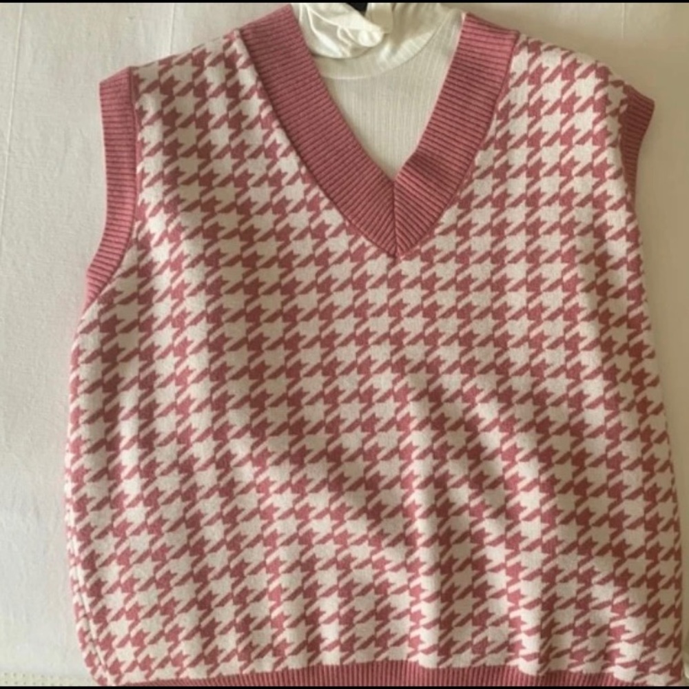 Pink and white sweater vest.